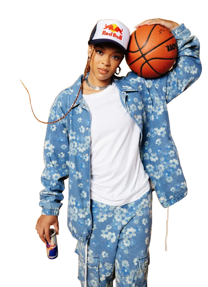 Hannah Hidalgo in a floral denim set with a basketball on her shoulder