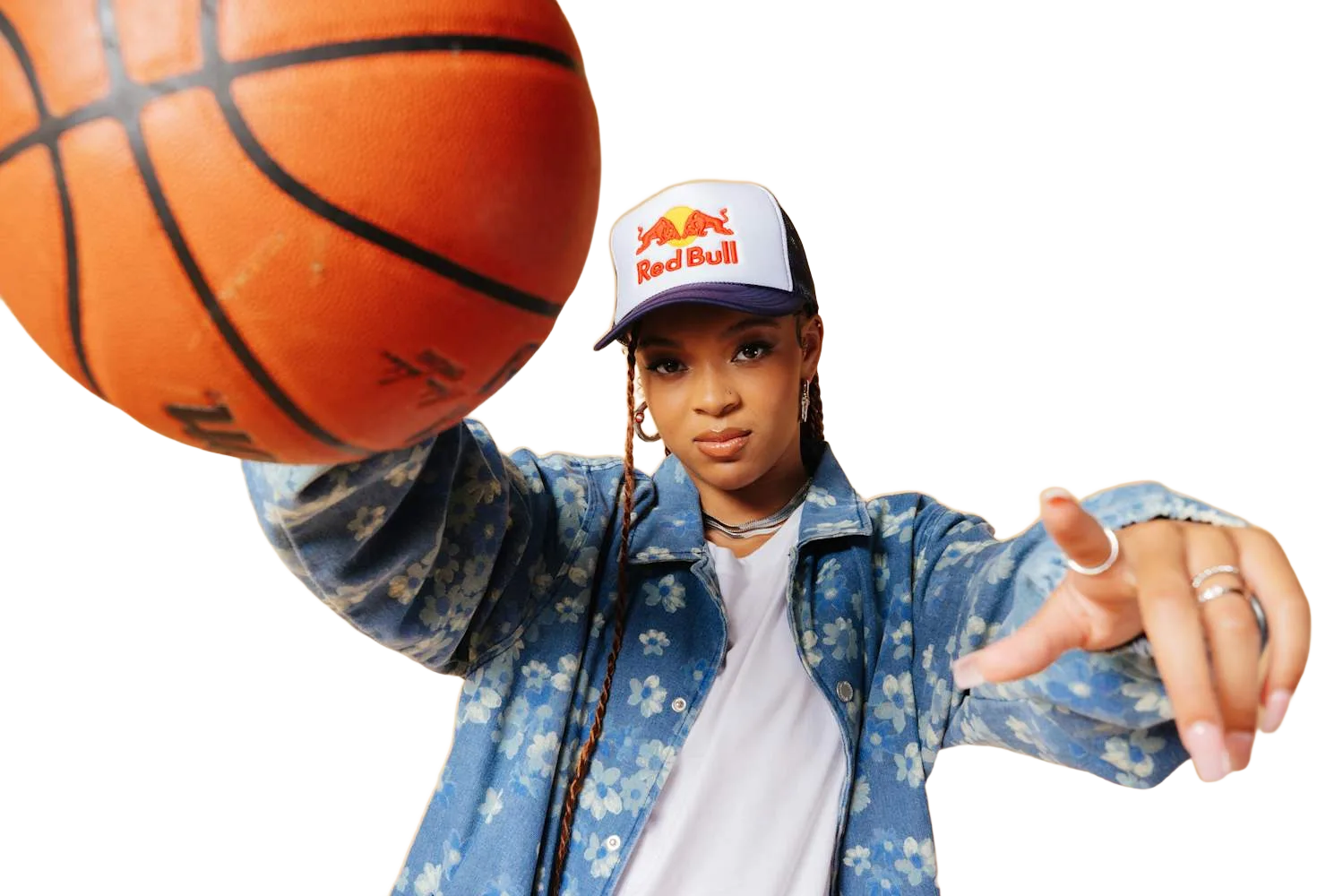 Hannah Hidalgo reaching toward the camera with a basketball in her other hand