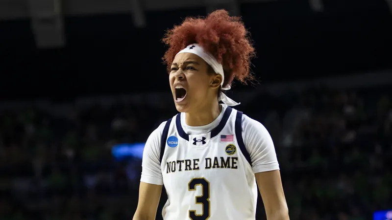 Hannah Hidalgo yelling in celebration in a white Notre Dame uniform